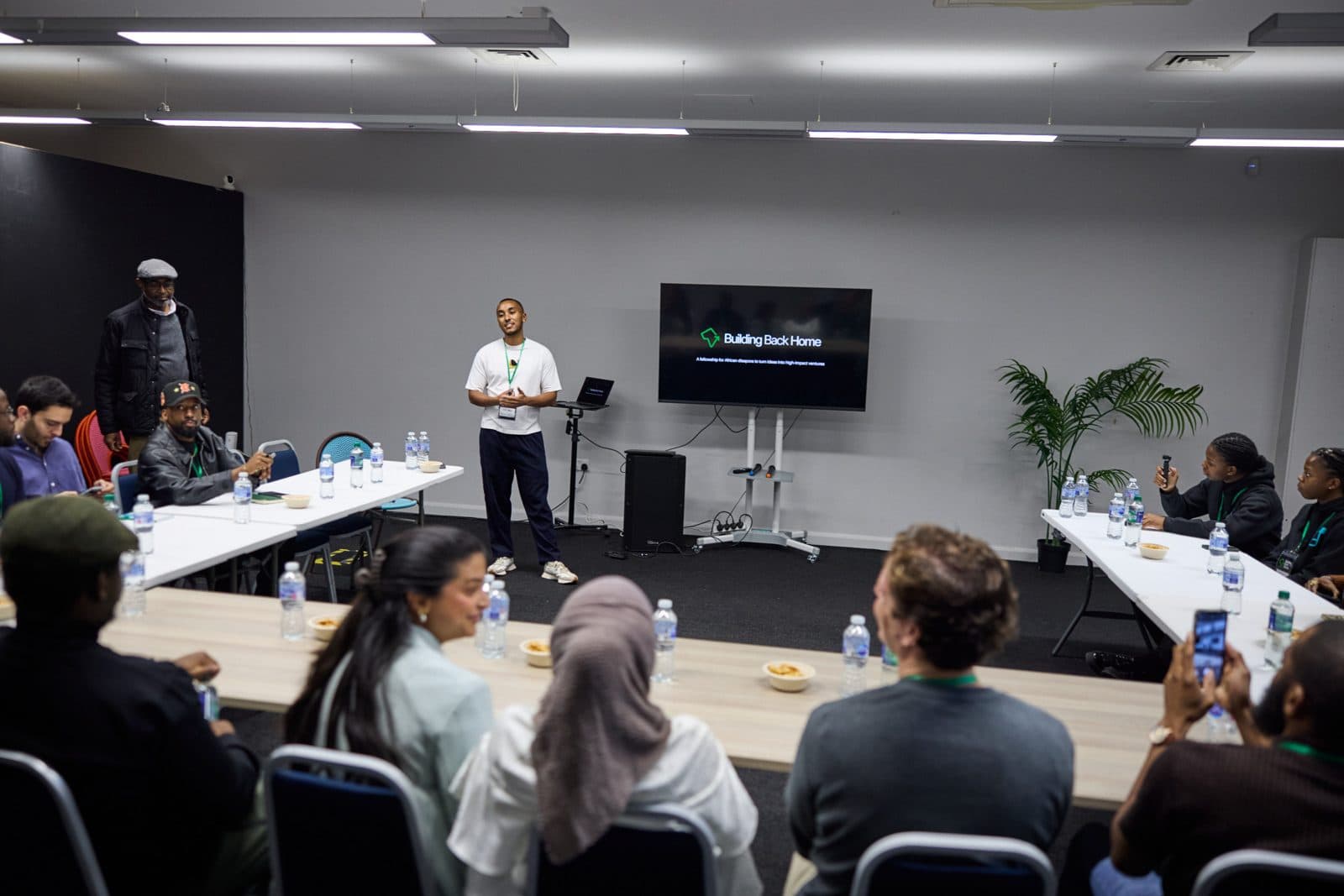 A speaker presenting to a room at a Building Back Home session