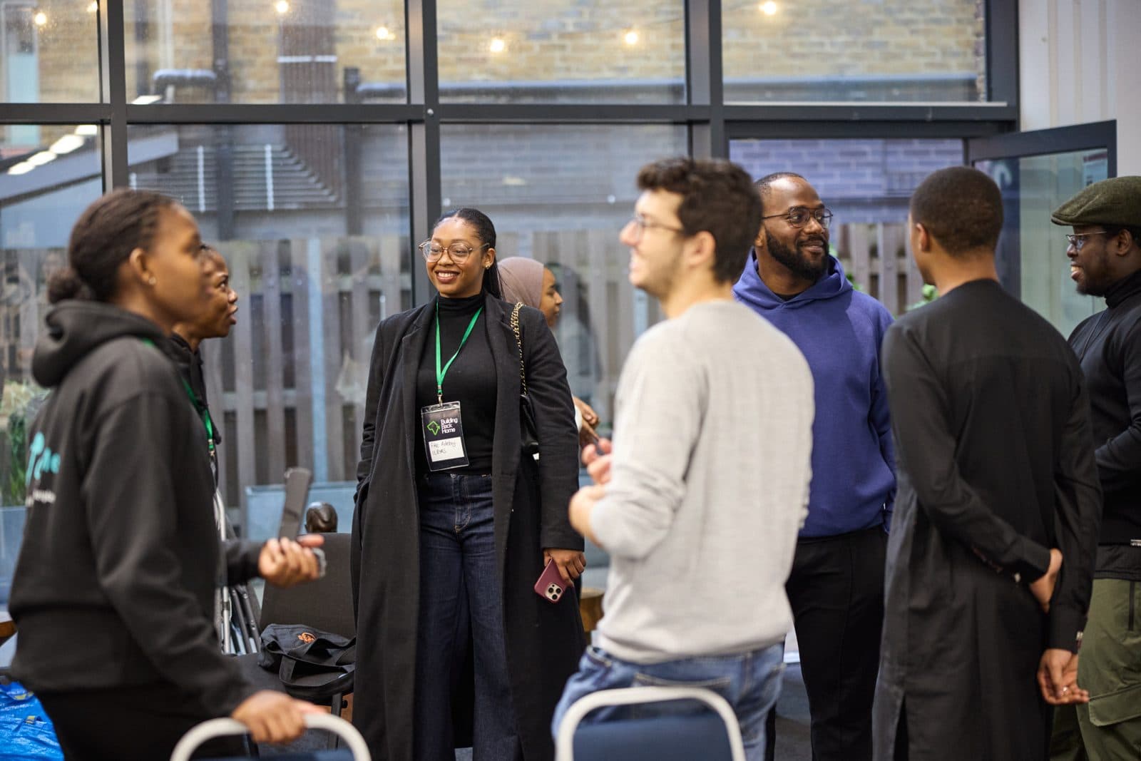 A room of people talking at a Building Back Home event